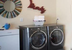 a washer and dryer in a room with a mirror at MagicwayVillas Paradise Pier Home - Across Disney in Anaheim