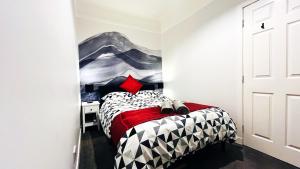 a bedroom with a bed with a painting on the wall at Ground Floor Entire Apartment Self Checkin in Crossgates