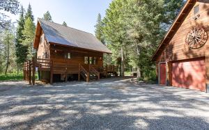 a large wooden barn with a garage next to it at Alpine Breakwater in Alpine