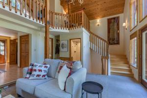 a living room with a couch and a staircase at Alpine Breakwater in Alpine +37 photos