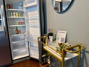 an open refrigerator with a cart in front of it at Moody Blues Studio Perfect For Work Or Romance in Memphis