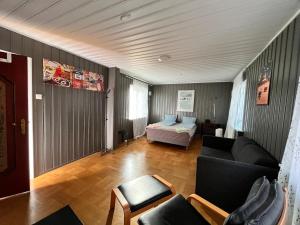 a living room with a couch and a bed at Big room in Charming Guest House in Oslo City 5 in Oslo