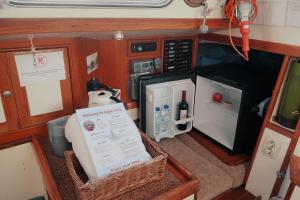 a small kitchen with a refrigerator and a microwave at Cozy Lisbon Marina Sleepaboard - Sail Away in Lisbon