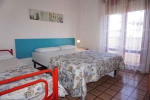 a small bedroom with two beds and a window at Apartment in Porto Santa Margherita 53410 in Porto Santa Margherita di Caorle