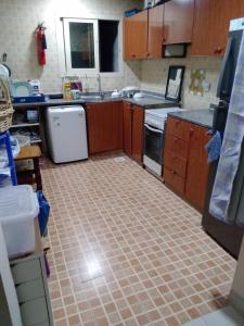 a kitchen with a tiled floor in a kitchen at Apka apna home kitchen in Sharjah