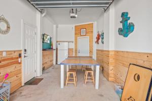a kitchen with a table and two stools at No Regrets PET FRIENDLY in Port Aransas