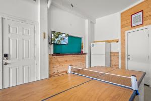 a room with a ping pong table and a refrigerator at No Regrets PET FRIENDLY in Port Aransas +38 photos