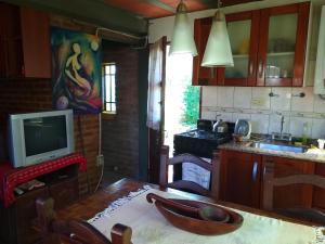 a kitchen with a wooden table with a bowl on it at Casita Loma Hermosa in Mina Clavero