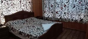 a bedroom with a bed with a laptop on it at Magnolia Homestay in Srinagar