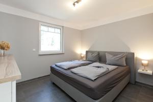 a bedroom with a bed with two pillows on it at unter den Kiefern 98 EG in Marienfelde +13 photos