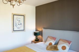 a bedroom with a bed and a chandelier at Luxury City Suite - Rosenheim in Rosenheim