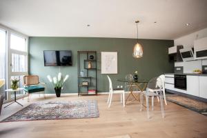 a living room with a table and chairs at Luxury City Suite - Rosenheim in Rosenheim