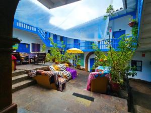un patio con sofás y mesas en un edificio en Hospedaje Euro's De San Blas, en Cusco