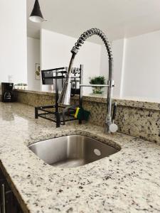 a kitchen counter with a sink and a faucet at Fontana del Valle Condominio 156 in San Pedro Sula