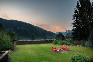 a group of red chairs sitting in a yard at Alpine Highmark in Alpine