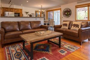 a living room with two leather couches and a coffee table at Alpine Highmark in Alpine