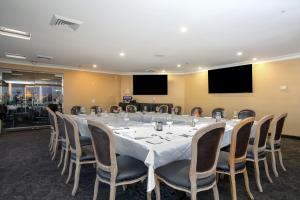 a large conference room with a long table and chairs at SeaVenture Beach Hotel in Pismo Beach