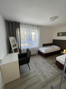 a bedroom with a bed and a desk and a couch at SECRA Exclusive Zum Sternberg in Münsingen