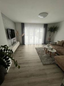 a living room with a couch and a table at Zum Sternberg in Münsingen +8 photos