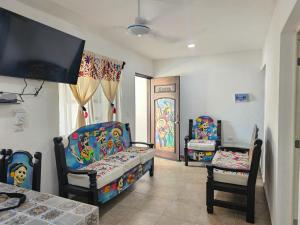 a living room with two chairs and a table at Hotel Villas Ponto Holbox in Holbox Island