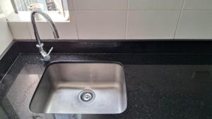 a kitchen sink with a faucet on a counter at El Derby 511 Aparts de 3 Dorm con Aire Acondicionado in Lima +20 photos