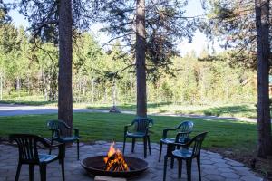 a group of chairs sitting around a fire pit at Lumberjack Lodge in Island Park