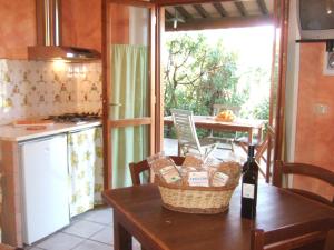 a kitchen with a table with a basket on it at Agriturismo QuartoPodere in Magliano in Toscana