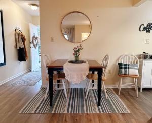a dining room with a table and chairs and a mirror at Smoky Hue in Gatlinburg