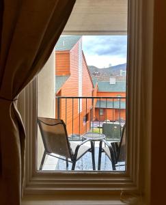 a window with a table and chairs on a balcony at Smoky Hue in Gatlinburg