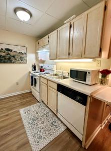 a kitchen with a sink and a microwave at Smoky Hue in Gatlinburg +14 photos