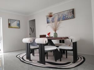 a dining room with a table and chairs at Dream home in Auckland