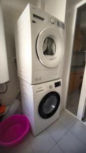 a dryer with a washing machine in a bathroom at Las Jacarandas Penthouse with Stunning Views & Private Rooftop in Benahavís