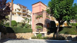 a building with a tree in front of it at Las Jacarandas Penthouse with Stunning Views & Private Rooftop in Benahavís
