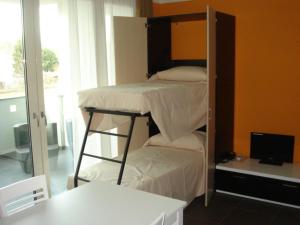 a room with a bunk bed and a desk with a computer at Guest House Residence Malpensa in Case Nuove