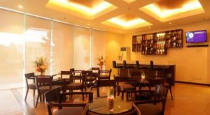 a dining room with tables and chairs in a restaurant at Verjandel Hotel in Manila