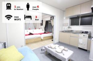 a small apartment with a bed and a table in a room at Hotel LUANA in Shin-Nakano in Tokyo