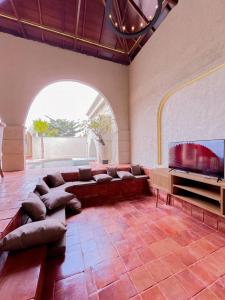 a living room with a couch and a flat screen tv at Princessa by Villa Raminten in Pakem