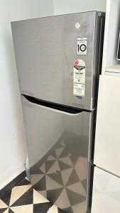 a refrigerator in a kitchen with a tile floor at Casa, Anjuna villa Vagator, with Pvt pool in Vagator