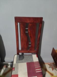 a wooden chair sitting in a room at Bruma in Papalotla