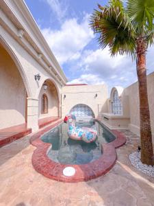 a swimming pool with an inflatable animal in a house at Princessa by Villa Raminten in Pakem
