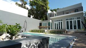 a house with a swimming pool in front of it at Puerto Rico vacation dream house in San Juan