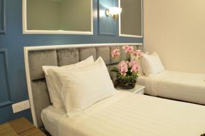 Postel nebo postele na pokoji v ubytování H Boutique Hotel Sri Petaling