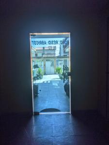 a door with a sign in the middle of a building at Apartamento charmoso in Rio das Ostras
