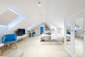 a white bedroom with a bed and a desk at Heritage hotel Viganj in Orebić