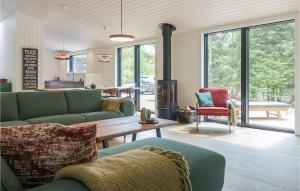 a living room with two green couches and a table at Lovely Home In Nexø With Kitchen in Neksø