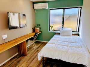 Tempat tidur dalam kamar di まち宿-machiyard-
