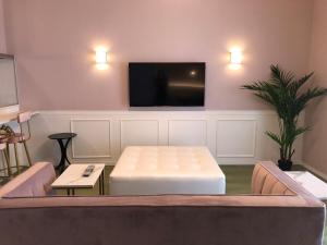 a living room with a couch and a flat screen tv at Mariposa Sea and Starry Garden Villa in Ishigaki Island +14 photos
