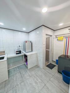 a kitchen with white walls and a refrigerator at Zzora Home 28 in Alor Setar