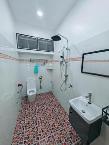 a bathroom with a toilet and a sink at Zzora Home 28 in Alor Setar