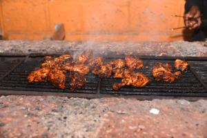 a bunch of food cooking on a grill at Hills and Valleys Resort in Dapoli